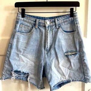 High waisted light blue distressed jean shorts, size 25